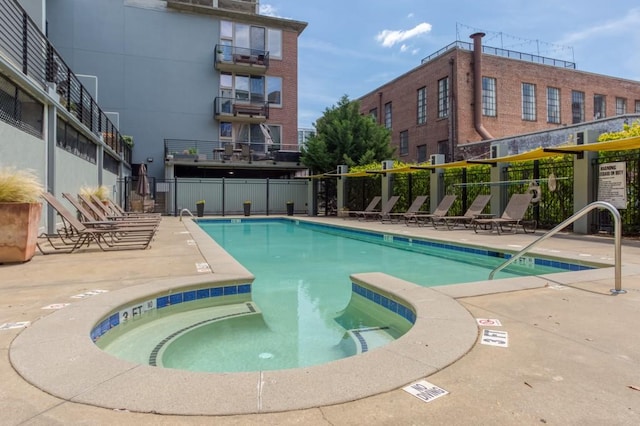 view of pool featuring a community hot tub and a patio