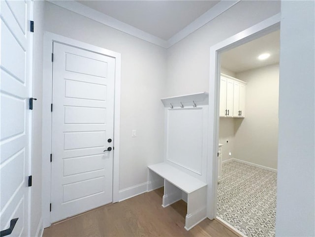 mudroom with light wood-type flooring and crown molding