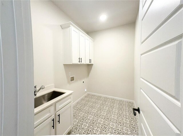 washroom featuring cabinets, sink, and hookup for a washing machine