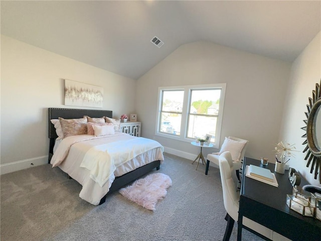 carpeted bedroom with lofted ceiling