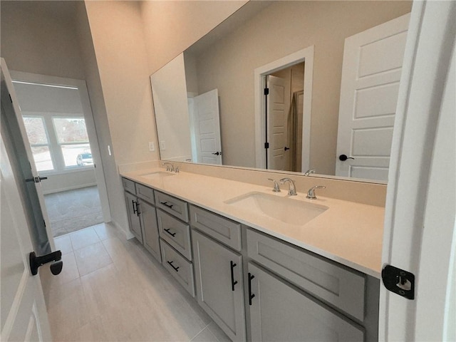 bathroom with tile patterned flooring and vanity