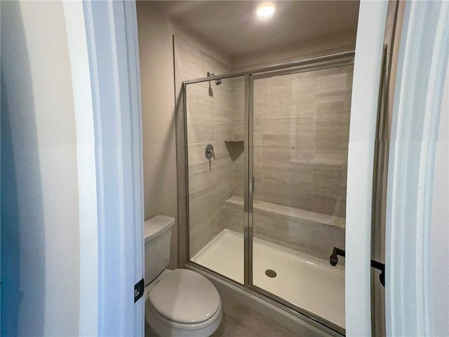 bathroom with toilet and walk in shower