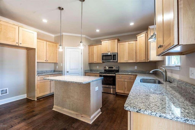 kitchen featuring appliances with stainless steel finishes, light stone countertops, a kitchen island, and light brown cabinetry