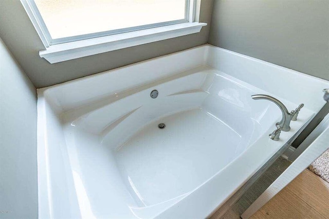 bathroom with a garden tub