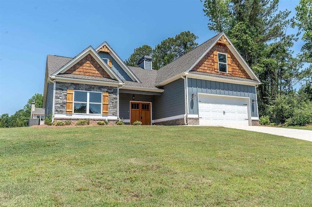 craftsman house with driveway, stone siding, a chimney, board and batten siding, and a front yard