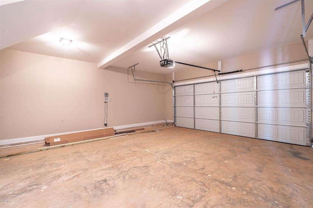 garage featuring a garage door opener and baseboards