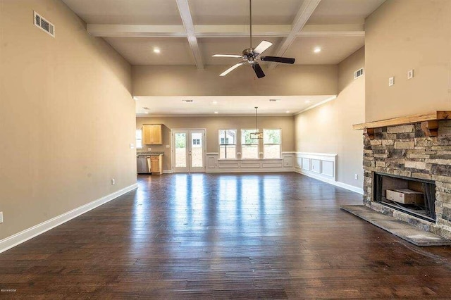 unfurnished living room featuring dark wood-style floors, a fireplace, visible vents, coffered ceiling, and beamed ceiling