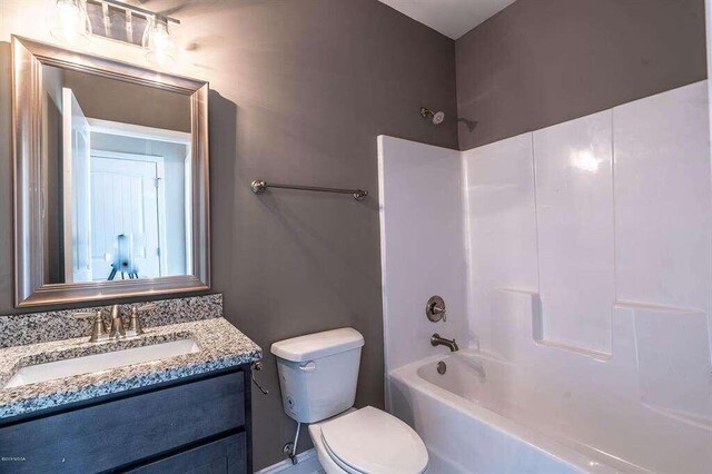 bathroom with toilet, bathing tub / shower combination, visible vents, and vanity