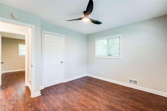 1401 Pine Ave, East Point, GA 30344 - unfurnished bedroom with dark wood-type flooring, ceiling fan, and a closet