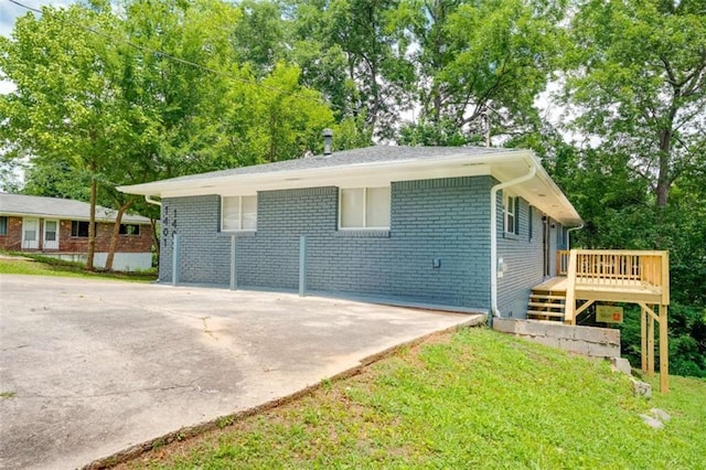 1401 Pine Ave, East Point, GA 30344 - view of property exterior featuring a wooden deck, brick siding, and view of wooded area