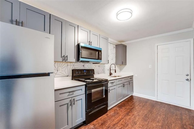 1401 Pine Ave, East Point, GA 30344 - kitchen featuring appliances with stainless steel finishes, gray cabinetry, backsplash, light countertops, and crown molding