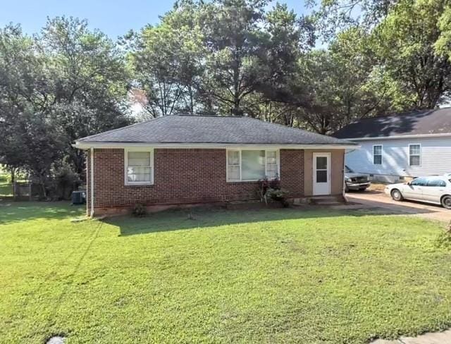 single story home with brick siding and a front yard