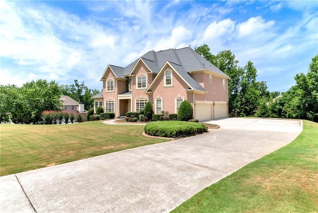 view of front of home featuring a garage and a front lawn