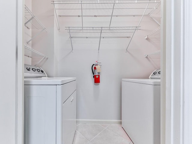 3334 Peachtree Rd NE Unit 614, Atlanta, GA 30326 - laundry area with washer and clothes dryer and light tile patterned floors