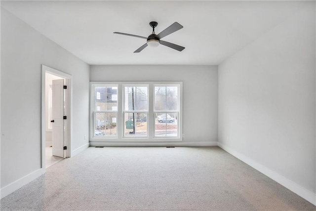 empty room with ceiling fan and light colored carpet