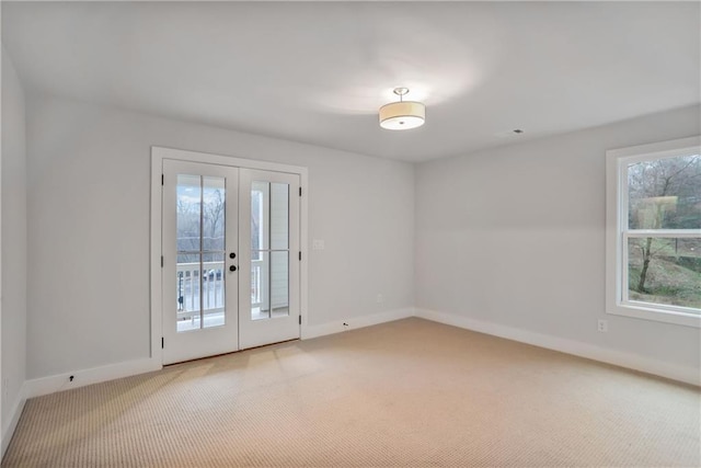 carpeted spare room with french doors