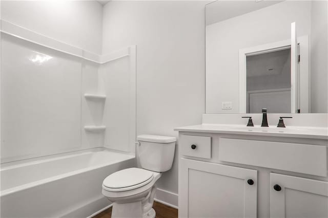 full bathroom featuring hardwood / wood-style flooring, shower / tub combination, vanity, and toilet