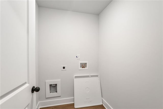 clothes washing area with electric dryer hookup, washer hookup, and dark wood-type flooring