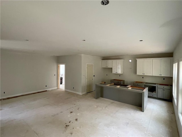 kitchen featuring white cabinetry, a healthy amount of sunlight, and a center island