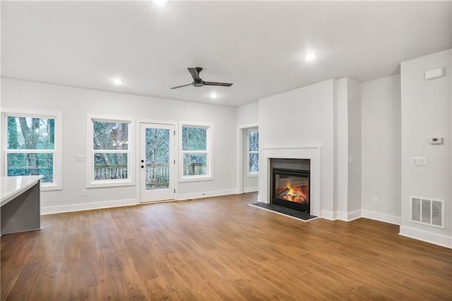 unfurnished living room featuring ceiling fan and wood-type flooring