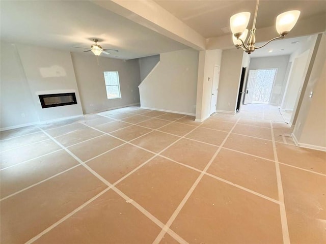 5518 Legacy Trl, Douglasville, GA 30135 - unfurnished living room featuring ceiling fan, a glass covered fireplace, a chandelier, tile patterned floors, and baseboards