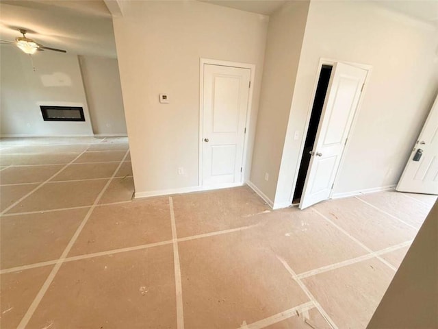 5518 Legacy Trl, Douglasville, GA 30135 - spare room featuring ceiling fan, baseboards, and a glass covered fireplace