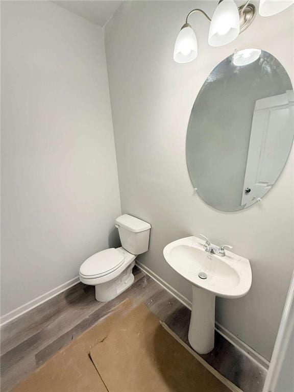 5518 Legacy Trl, Douglasville, GA 30135 - bathroom featuring wood finished floors, toilet, and baseboards