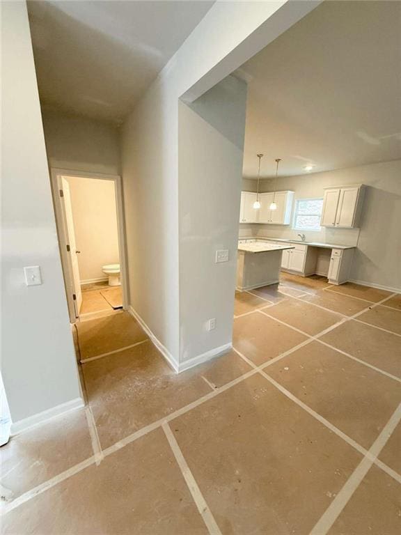 5518 Legacy Trl, Douglasville, GA 30135 - kitchen with white cabinets, decorative light fixtures, baseboards, and light countertops