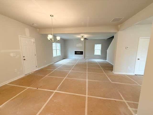 5518 Legacy Trl, Douglasville, GA 30135 - unfurnished dining area with healthy amount of natural light, a chandelier, baseboards, and tile patterned flooring