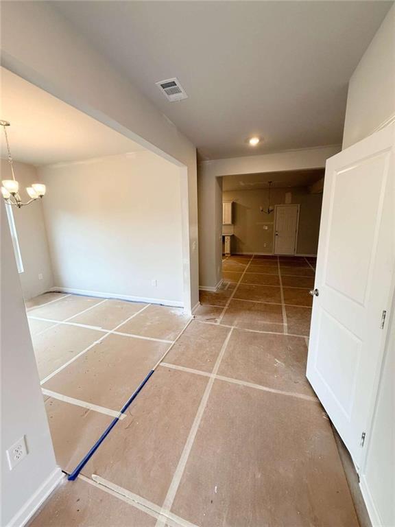 5518 Legacy Trl, Douglasville, GA 30135 - hallway featuring a chandelier and recessed lighting
