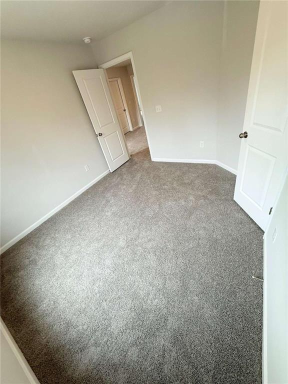 5518 Legacy Trl, Douglasville, GA 30135 - carpeted spare room featuring baseboards