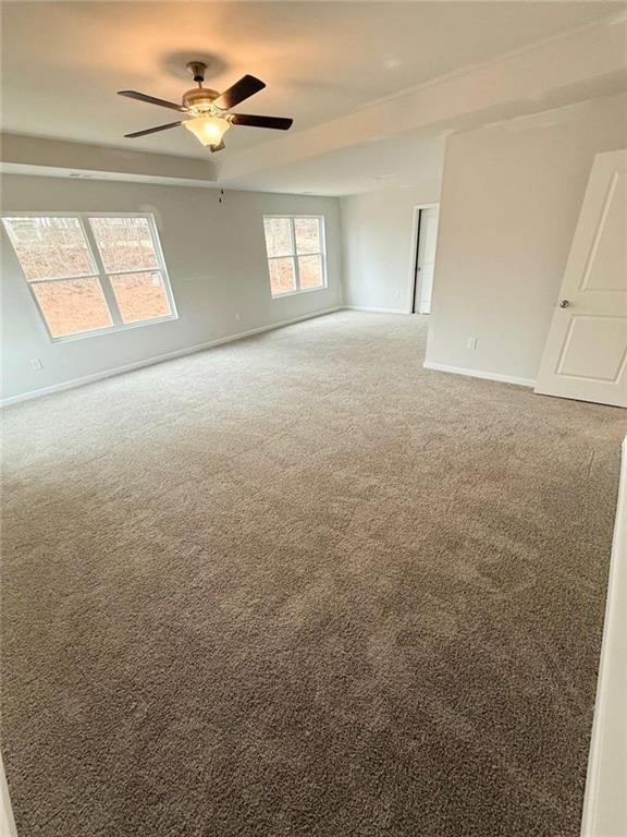 5518 Legacy Trl, Douglasville, GA 30135 - unfurnished room featuring light carpet, baseboards, and a ceiling fan