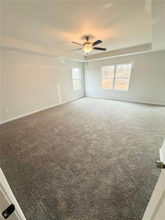 5518 Legacy Trl, Douglasville, GA 30135 - empty room featuring carpet flooring, baseboards, and a tray ceiling