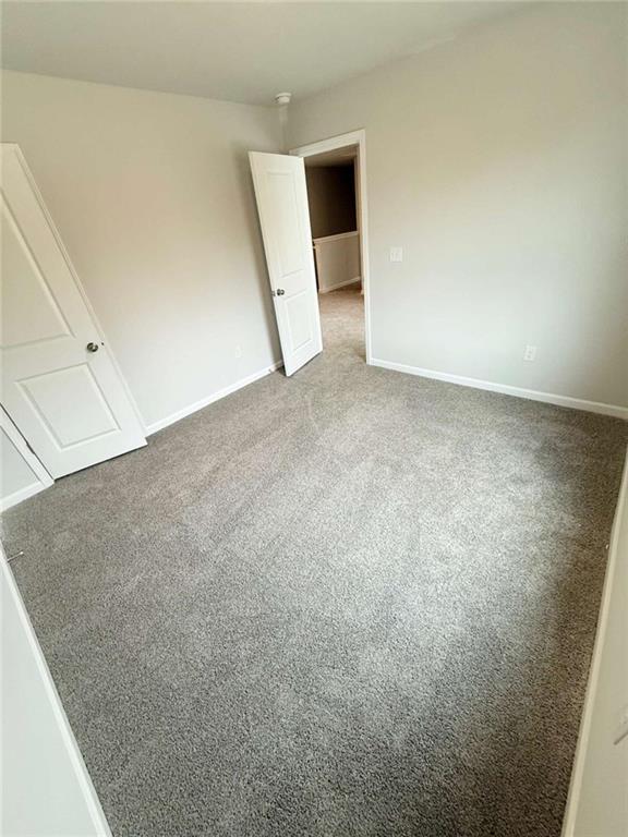 5518 Legacy Trl, Douglasville, GA 30135 - unfurnished bedroom featuring carpet and baseboards