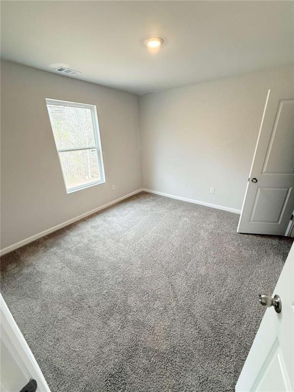 5518 Legacy Trl, Douglasville, GA 30135 - carpeted spare room featuring baseboards