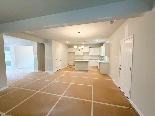5518 Legacy Trl, Douglasville, GA 30135 - kitchen with a chandelier, baseboards, white cabinets, open floor plan, and recessed lighting