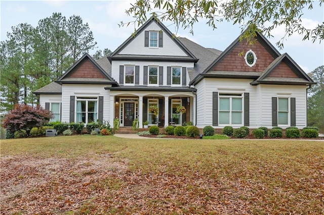 craftsman-style house with a porch and a front yard