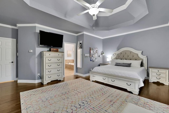 bedroom with dark wood-type flooring, ensuite bathroom, a raised ceiling, crown molding, and ceiling fan