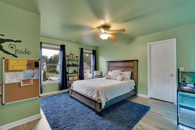 bedroom featuring hardwood / wood-style flooring and ceiling fan