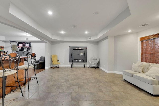 workout room with a raised ceiling