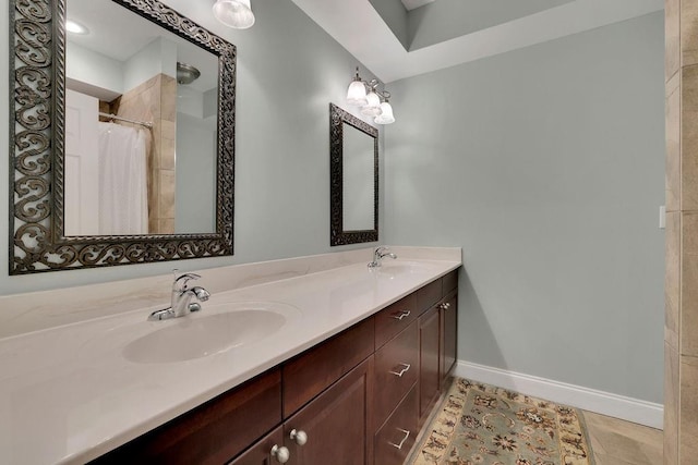 bathroom with a shower with curtain, tile patterned flooring, and vanity