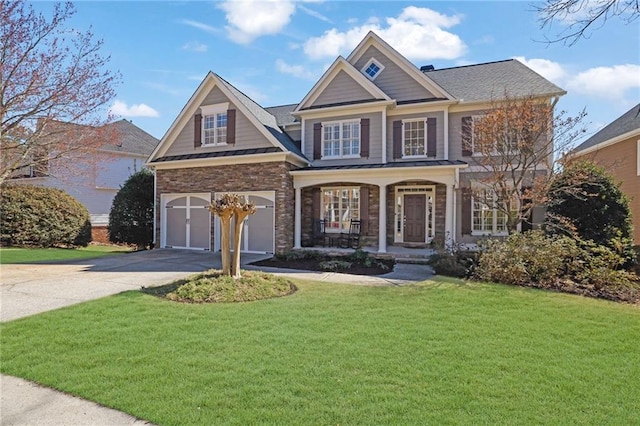 view of front facade with a front lawn, an attached garage, covered porch, and driveway