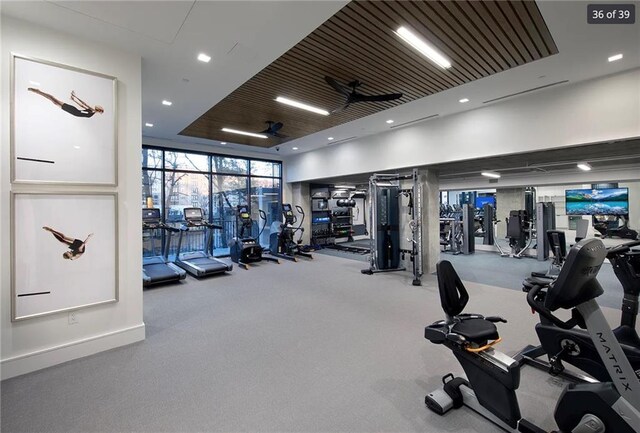 gym with ceiling fan and floor to ceiling windows