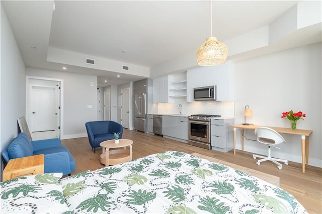 living room featuring light hardwood / wood-style flooring and sink