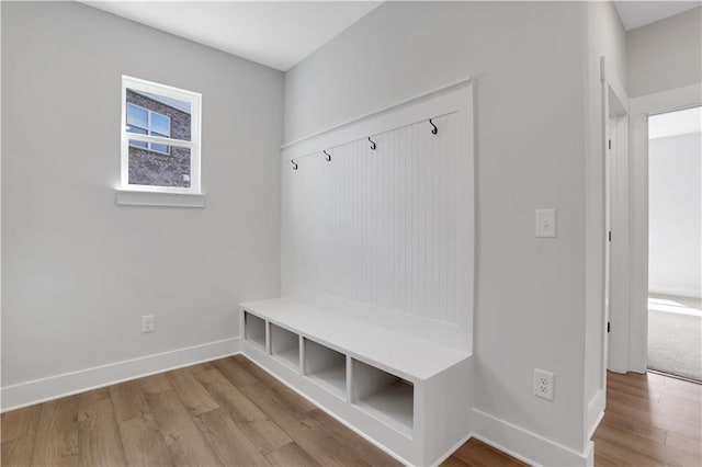 mudroom featuring baseboards and wood finished floors