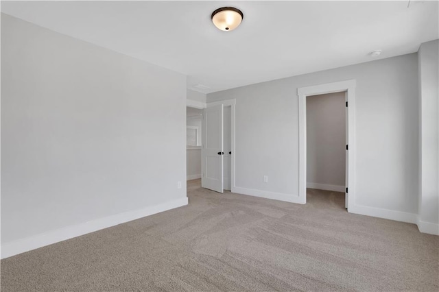 spare room with carpet flooring and baseboards