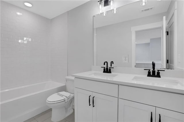 full bath featuring double vanity, visible vents, a sink, and toilet