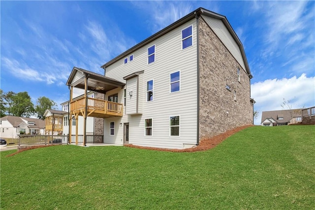 back of house with a yard, a ceiling fan, and a patio
