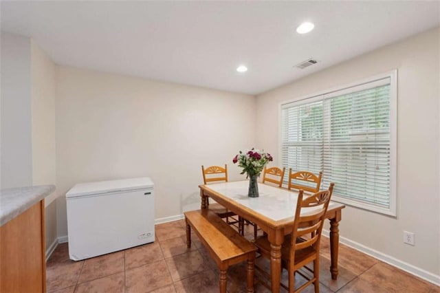 dining area with light tile patterned floors, recessed lighting, and baseboards