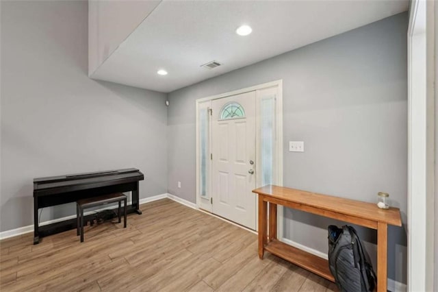 entryway featuring wood finished floors, recessed lighting, and baseboards